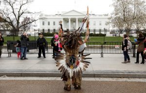 Little Thunder, a traditional dancer and indigenous activist from the Lakota tribe, dances as he demonstrates in front of the White House during a protest march and rally in opposition to the Dakota Access and Keystone XL pipelines. REUTERS/Kevin Lamarque