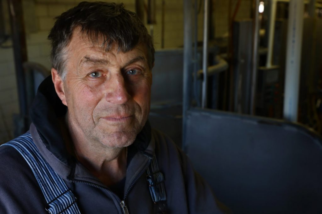 John Rosenow, owner of Rosenholm Farm, in Cochrane, Wis., says an immigration raid could shut down his business. ÒI wouldn't be able to farm anymore, and it would just about kill me.Ó He is pictured in the milking parlor at his farm on March 8, 2017. Photo by Coburn Dukehart.