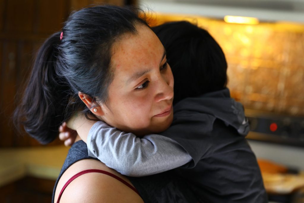 ÒRosaÓ hugs her 3-year-old son at their home on a dairy farm in Pepin County, Wis. on March, 8, 2017. Her husband, ÒManuelÓ is a laborer on the farm. She says her family has experienced racial slurs since President Donald Trump took office. They are planning to join the growing flow of immigrants back across the U.S.-Mexico border. Family members do not want their real names used because of their immigration status. Photo by Coburn Dukehart.