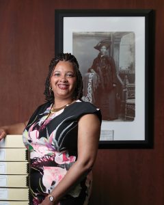 Vaunce, inside the Wisconsin Historical Society Archives at 816 State Street in Madison. Behind her is an 1893 studio portrait of Mrs. William W. “Fannie” Hendricks that appears in the book Wisconsin Death Trip, by Michael Lesy.