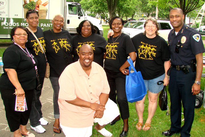 Sina Davis (third from right) with Mothers in the Neighborhood at Juneteenth in 2011 with former Madison Police Chief Noble Wray (far right) and Boys and Girls Club CEO Michael Johnson (front). (Photo by David Dahmer)