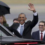 U.S. President Barack Obama waves while standing in front of Cuba’s foreign minister Rodriguez in Havana