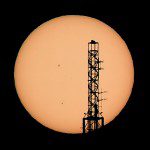 The top of the Stratosphere tower is silhouetted as the planet Mercury is seen, lower left quadrant, transiting across the face of the sun in Las Vegas