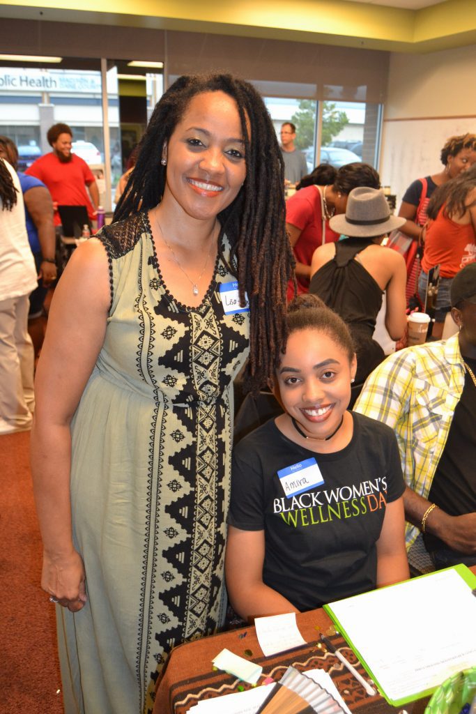 Lisa Peyton Caire and daughter, Amari, hand out information about Black Women Wellness Day at the Black Business Expo.