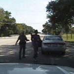 Still image of Texas state trooper Brian Encinia pointing a Taser as he orders Sandra Bland out of her vehicle in Prairie View