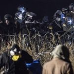 Police confront protesters with a rubber bullet gun during a protest against plans to pass the Dakota Access pipeline near the Standing Rock Indian Reservation, near Cannon Ball, North Dakota, U.S.
