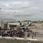 Travelers are evacuated out of the terminal and onto the tarmac after airport shooting at Fort Lauderdale-Hollywood International Airport in Florida