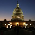 The U.S. Capitol Building is lit at sunset in Washington