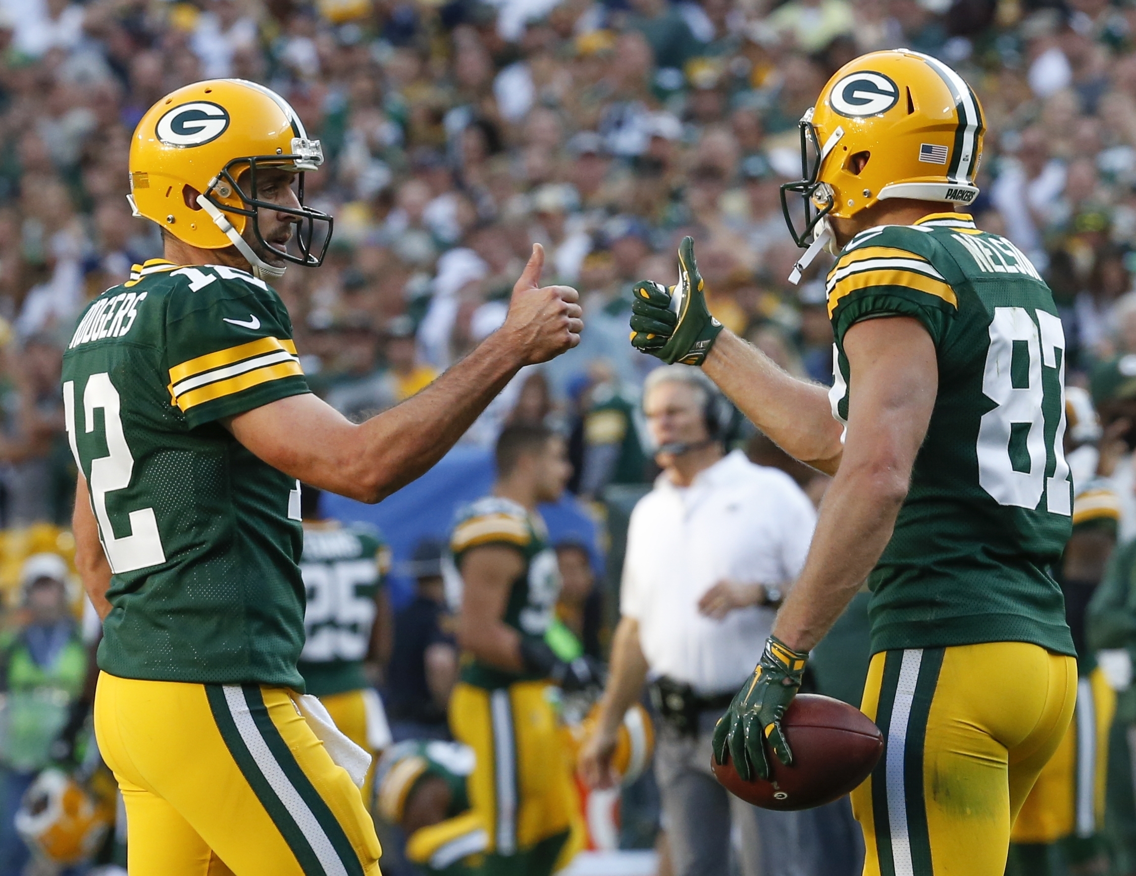 Green Bay Packers' Aaron Rodgers gives Jordy Nelson (87)