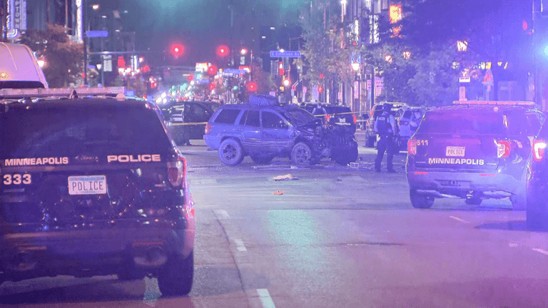 A woman is dead after a car drove through a crowd of protesters in Minneapolis, police say