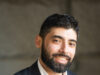 Two hats, one mission: Monis Khan balances sports media and public service